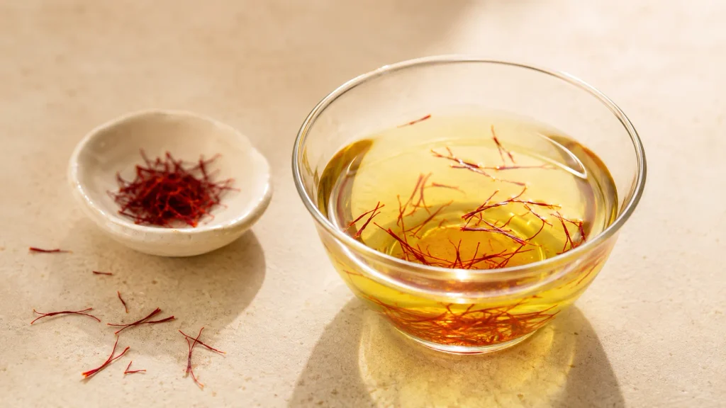 Premium saffron threads with saffron infusion in a glass cup